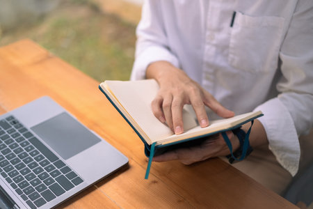 Above view of businessman writing startup business ideas or important things on notebook.