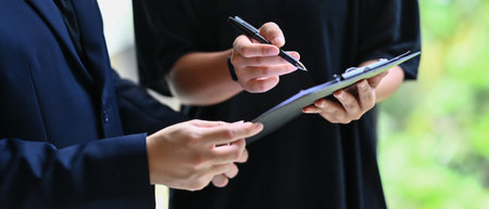 Businesspeople analyzing the results, reviewing project with colleagues in modern office.の写真素材