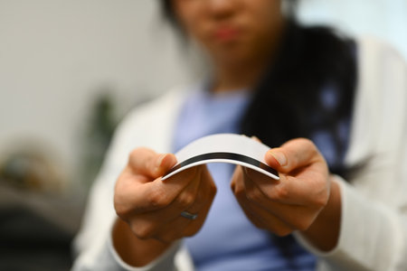 Upset woman solving problems by destroying her credit card. Bankruptcy, financial problems concept.の写真素材