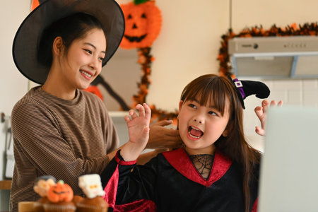 Loving mom and daughter preparing for Halloween party. The concept of Halloween.の写真素材