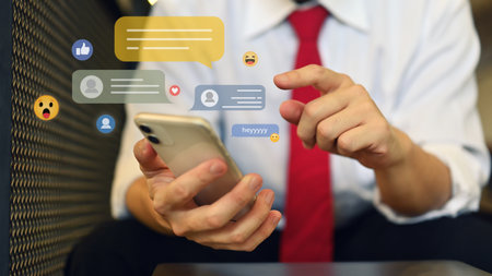 Cropped shot of young businessman using mobile phone for commenting in online community.