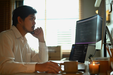 Skilled male software developer programming code on the computer for cyber security.