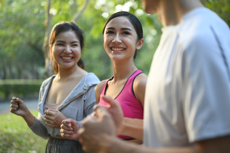 Fitness men and women running on a sunny day in the public park. Healthy lifestyle conceptの写真素材