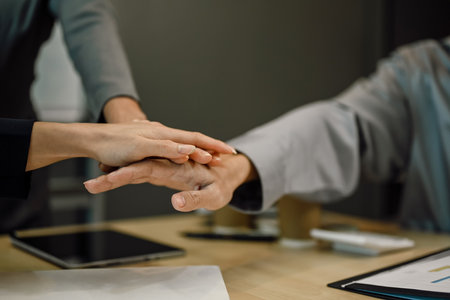 Cropped shot of business team stacking hands together at meeting table. Concept of corporate unity and solidarity.の写真素材