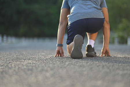 Athletic man in starting position getting ready for morning run.の写真素材