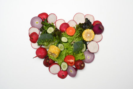 Heart made of various raw vegetables. Flat lay, top view and healthy food conceptの写真素材