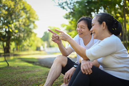 Happy old couple relaxing in the park, enjoying a beautiful day togetherの写真素材