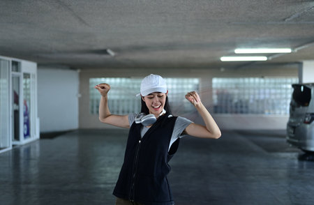 Talented young woman dancing Hip hop dance in parking garage. Hobby and active lifestyle concept.