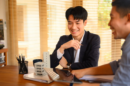 Two young architects working on new construction project in an office.の写真素材