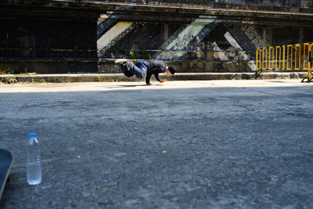 Young man dancing hip hop dance on shows a dance performance on the street.
