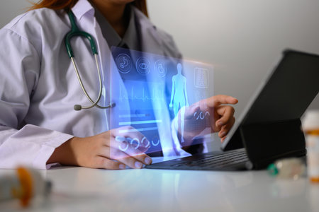 Doctor in uniform using digital tablet with electronic medical record on virtual screen. Medical...