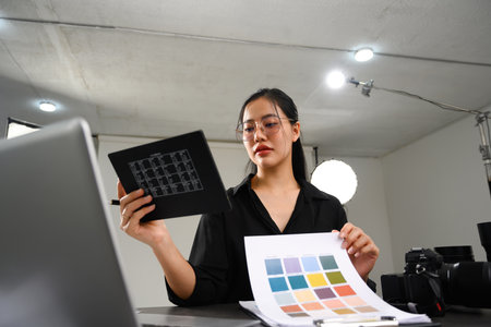 Creative Asian woman working on a new project at her studio.
