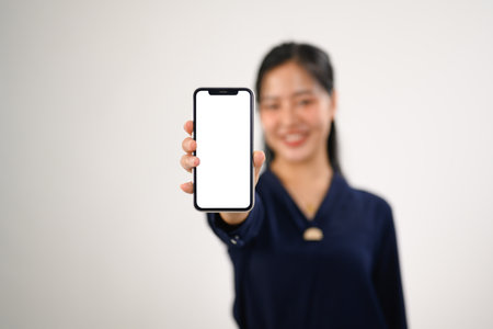 Portrait of a smiling woman showing smartphone for your webpage or advertise text.