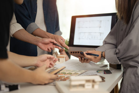 Group of designers of interior choosing material samples, working together at creative office.の写真素材