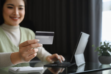 Select focus on woman hand holding credit card. Shopping online concept.