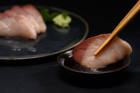 Close up pickled mackerel served with wasabi and soy sauce on black background.の写真素材