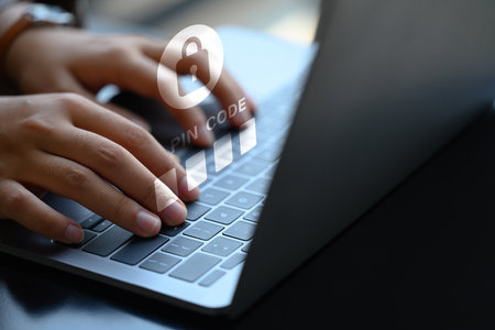 Hands entering pin code on laptop. User privacy security and protect personal data concept.