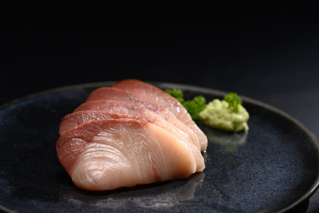 Shime Saba or raw mackerel salted and marinated in vinegar on black plate. Japanese food style.の写真素材