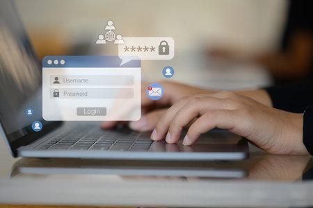 Woman hands typing username and password on her laptop to access account on website.