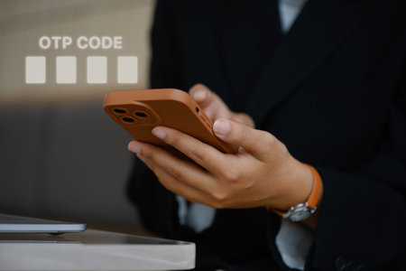 Woman entering verification code on her mobile phone for login. User privacy security concept.の写真素材