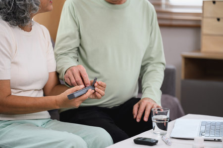 Snior wife giving daily prescription medication to her husband. Healthcare concept.