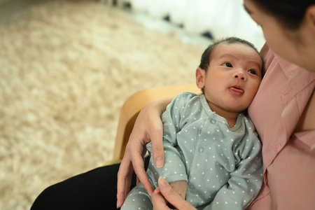 Tender moment between a mother and her newborn baby at home. Motherhood and Love moment concept.の写真素材