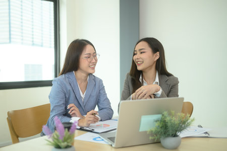 Happy business colleagues working together in a modern co working space.の写真素材