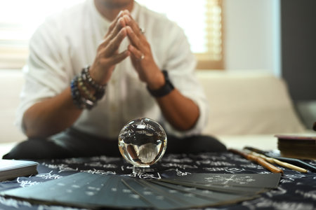 Male fortune teller forecasting a crystal ball on desk. Magical power, forecasting and divination concept.の写真素材