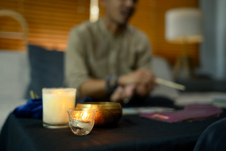 Burning candles, Tibetan singing bowl creating mystical and serene atmosphere ob fortune teller desk.の写真素材