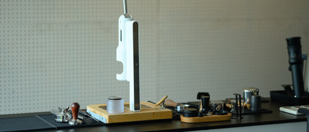 Stylish modern cafe interior with espresso machine and various barista tools on stone counter.