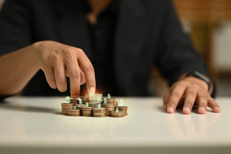 Fingers walking up on stack of coins. Financial growth and investment returns concept.