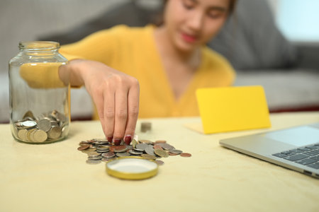 Happy young woman organizing or counting the money. Saving money and financial responsibility...