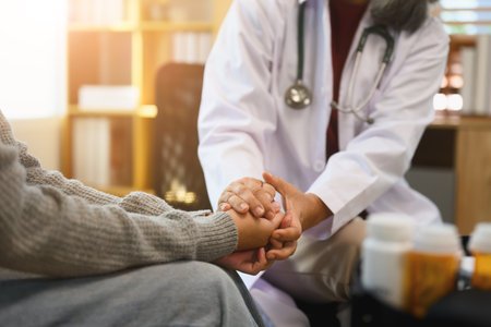Psychiatrist or healthcare professional gently holding patient hand comforting and encouragement. Mental health care concept.の写真素材