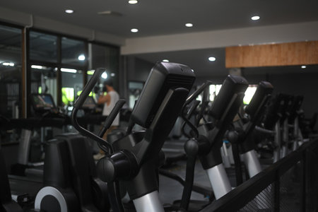 Row of elliptical machines in a modern gym.Fitness equipment, workout, healthy lifestyle concept.