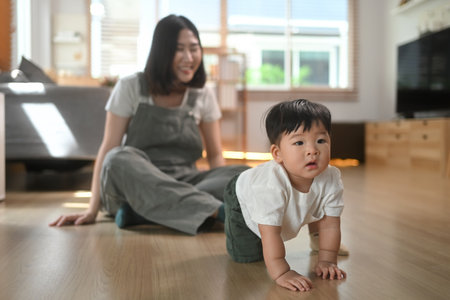 Adorable baby boy crawling on the floor, explore their surroundings Child development and nurturing...