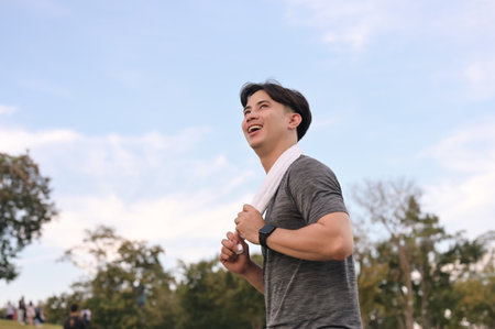 Young athlete running with scenic mountain views. Healthy lifestyle concept.の写真素材