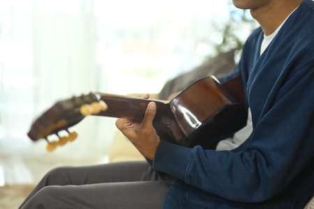 Closeup man playing guitar relaxation time.