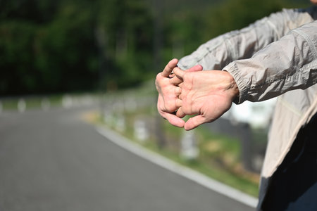 Fit sportsman stretching his arms getting ready for outdoor exercise.の写真素材