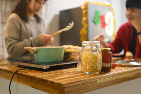 Close up of ingredients for a homemade pasta dish in a decorated kitchen.の写真素材