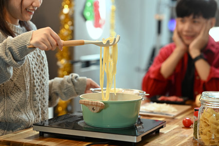 Loving young couple preparing dinner together during the festive season.の写真素材
