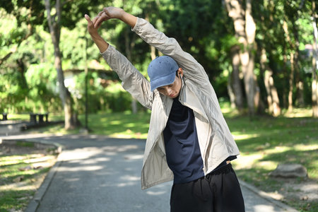 Young sportsman stretching his arms, warm up and ready for training or workout.