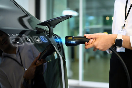 Closeup woman plugging electric car from charging station. Alternative energy and transportation...