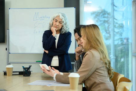Professional business team brainstorming ideas during a work session in a modern office.の写真素材