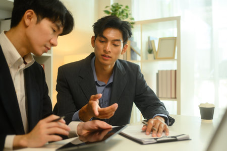 Professional lawyer in formalwear discussing contract terms with client during at office.の写真素材