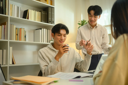 Smiling tutor helping his students with assignment during a tutoring session.
