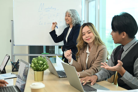 Professional marketing team discussing strategies during meeting in the modern office.