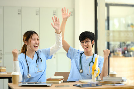 Smiling medical students celebrating a breakthrough in their studies and achievement.の写真素材