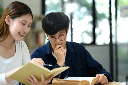 University students collaborating on a project in a modern library or co working space.の写真素材