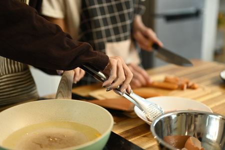 Close up of a gay couple preparing a meal in the kitchen.の写真素材