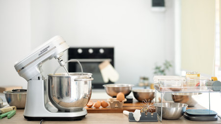 Baking station with stand mixer, fresh ingredients and baking tools ready for homemade cookies.の写真素材